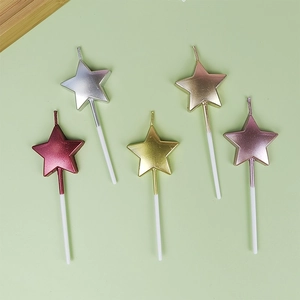 Five metallic star-shaped birthday candles in red, silver, gold, and rose gold finishes