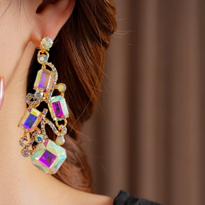 Close-up of elegant square crystal earring with gold base on model, vintage style