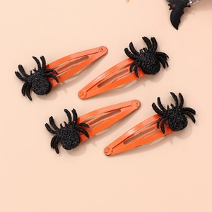 Detail of four black glitter spider hair clips on orange metal clips for Halloween