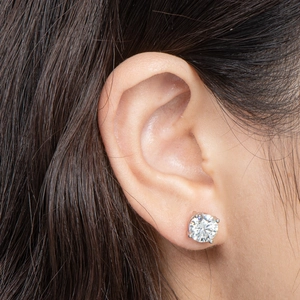 Close-up of 2 carat D color moissanite stud earring in 925 silver worn by a model