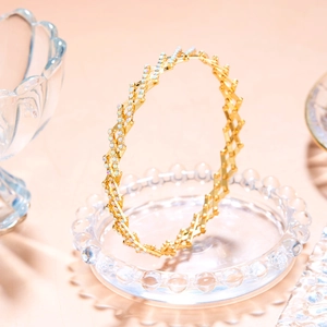 Detail of creative golden magic telescopic ring with shiny multi-row rhinestones