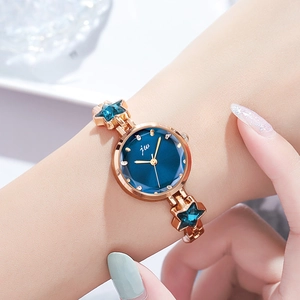 Elegant gold starfish bracelet watch for women featuring a blue dial and sparkling crystal stars