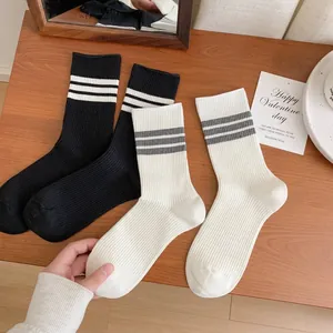 Striped mid-calf crew socks in black and white with classic ribbed cotton texture