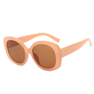 Chic oval oversized sunglasses in apricot with tinted brown lenses for stylish women