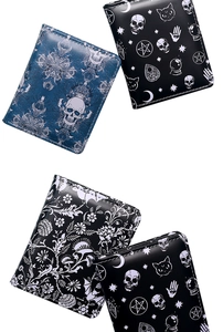 Detail of gothic skull and celestial print leather wallets in navy blue and black tones