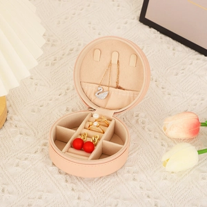 Detail view of pink PU leather jewelry box interior with necklace hooks and velvet slots