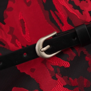 Elegant halter neck dress featuring a red and black jacquard fabric with a waist belt detail
