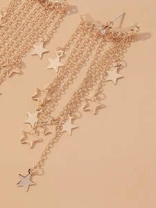 Detailed view of elegant gold tassel earrings featuring layered star pendants and crystals