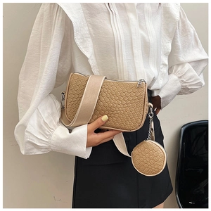 Close-up of khaki woven texture handbag with detachable round coin purse and wide strap