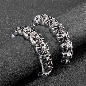 Detail view of retro silver skull and cross link bracelet in punk gothic steel style