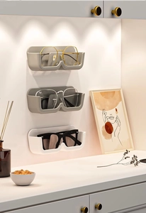 Vertical wall mounted glasses holders in white and grey colors shown on a white wall