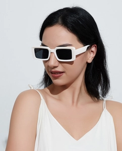 Close-up of stylish white square frame sunglasses on model featuring black lenses