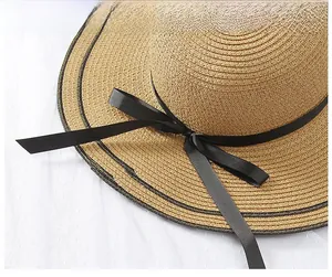 Detail of high-density straw weave with black ribbon bow and dual-line brim stitching
