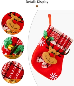 Détails d'une chaussette de Noël avec renne 3D, bordure à carreaux et clochette dorée