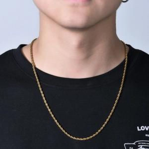 Close-up of a 3mm gold-plated stainless steel rope chain necklace on a male model