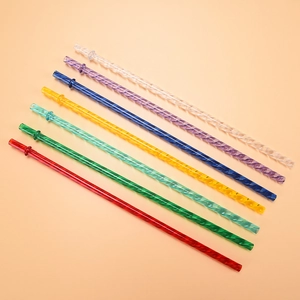 Detailed view of eight colorful spiral Tritan straws with anti-drop buckle on peach background