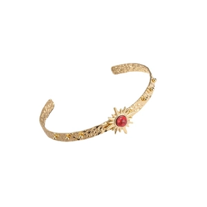 Golden C-shaped open cuff bangle with sunburst design and red marble stone inlay