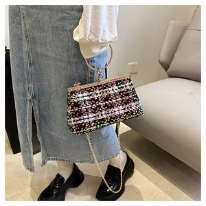 Detail of colorful sequin fabric texture with golden ring handle and metal chain