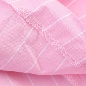 Macro du tissu à rayures roses et blanches avec surjet précis et texture de sergé fine
