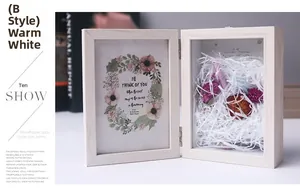Detail of warm white wooden shadow box frame featuring dried flowers and 4x6 art card