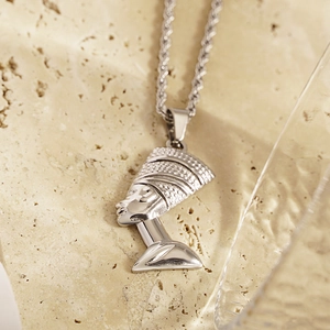 Silver Nefertiti pendant necklace in stainless steel on a stone base, macro view