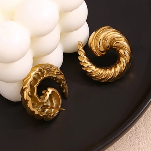 Close-up of 18K gold plated stainless steel earrings with spiral swirl texture