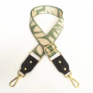 Adjustable wide canvas shoulder strap with green pattern and brown leather ends