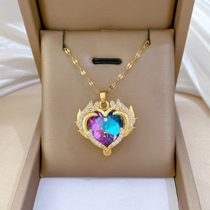 Detailed macro shot of a heart-shaped gradient crystal pendant with rhinestone border