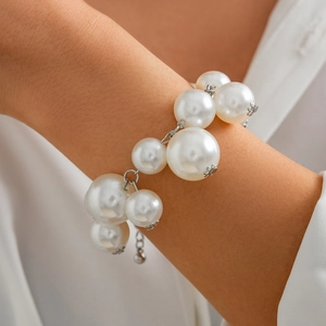 Detail of multi-size white pearls and silver metal chain link on a fashion necklace