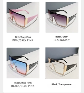 Detail of oversized square sunglasses featuring woven texture temples and metal accents