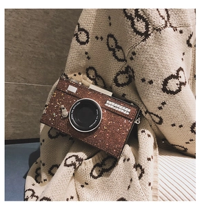Close-up detail of retro camera crossbody bag with brown sequins and chain strap