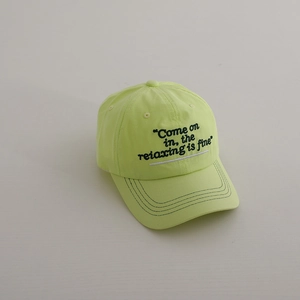Detail of embroidered lettering on neon yellow summer breathable cotton baseball cap