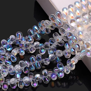Macro detail of tear-drop iridescent glass beads with rainbow luster for jewelry DIY