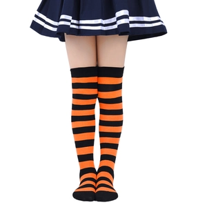 Detail of girls' orange and black striped over-knee socks in high-quality knitted fabric