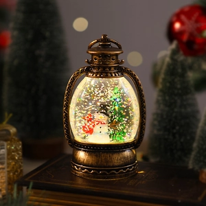 Macro shot of a vintage Christmas lantern snow globe with snowman on an old book