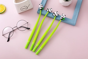Close-up of cute 3D panda figures on green gel pens with creative office stationery detail