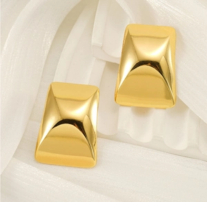 Macro shot of 18k gold plated rectangular earrings with 3D pyramid texture and mirror finish