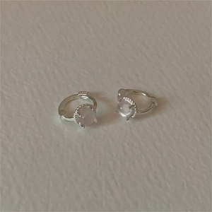 Detailed macro view of S925 sterling silver hoop earrings with translucent cat eye stones