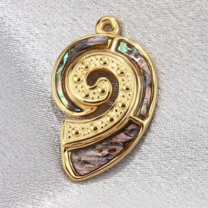 Detailed macro view of spiral shell pendant with golden frame and iridescent inlay