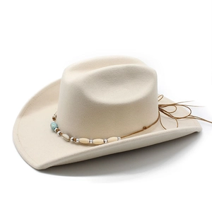 Detail of ethnic western cowboy hat with turquoise beads and shell tassel decorations