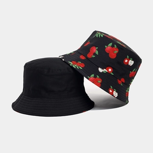 Detail of fruit print bucket hat with stitched brim and black cotton sun hat textures