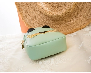 Detail of mint green cat-shaped backpack with heart nose and metallic whiskers