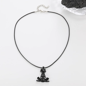 Close-up of black frog pendant necklace with shimmering crystals and wax cord strap