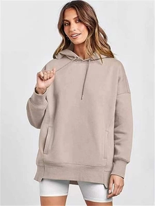 Detail of side split hem and heavy cotton texture on oversized khaki hoodie