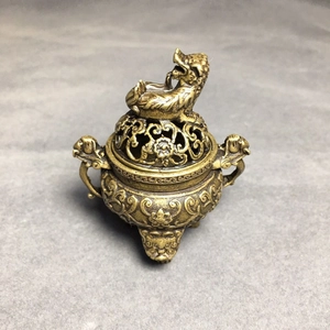 Detailed view of hollow carved bronze incense burner lid with mythical beast finial