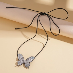 Detailed view of butterfly rhinestone pendant with adjustable black cord on display