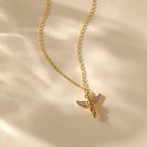 Close-up of golden Cupid angel pendant with sparkling rhinestones on fine link chain