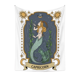 Macro view of Capricorn zodiac tapestry with artistic sea-goat illustration and gold stars