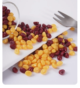 Miniature chestnuts DIY craft accessories in dark red and yellow colors on ceramic surface