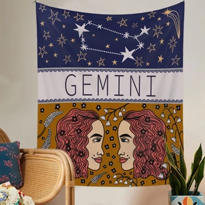 Detailed view of Gemini zodiac tapestry hanging on wall with bohemian interior decor